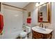 Simple bathroom with tub and dark wood vanity at 6143 Basilone Ave, Las Vegas, NV 89122