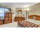 Cozy bedroom with wood furniture and a colorful quilt at 6143 Basilone Ave, Las Vegas, NV 89122