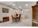 Dining area with a round table, chandelier, and view of the kitchen at 6143 Basilone Ave, Las Vegas, NV 89122