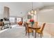 Bright dining room featuring a wood table, chandelier, and fireplace at 6143 Basilone Ave, Las Vegas, NV 89122