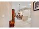 View of the entryway looking toward a dining room with a chandelier and a wooden table at 6143 Basilone Ave, Las Vegas, NV 89122