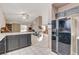 Kitchen features dark cabinets, breakfast bar, and views into living room at 6143 Basilone Ave, Las Vegas, NV 89122