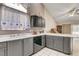 Kitchen with gray cabinets, white countertops, and built-in dishwasher at 6143 Basilone Ave, Las Vegas, NV 89122