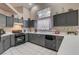 Bright kitchen with dark cabinets, white countertops, and a large window at 6143 Basilone Ave, Las Vegas, NV 89122