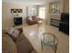 Living room with fireplace, tiled floors, and large windows at 2760 Stargate St, Las Vegas, NV 89108