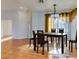 Virtually staged dining room with hardwood floors and chandelier at 445 Wright Way, Henderson, NV 89015