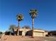 House exterior with two palm trees and attached garage at 445 Wright Way, Henderson, NV 89015