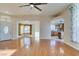 Open concept living room with hardwood floors and kitchen view at 445 Wright Way, Henderson, NV 89015