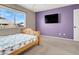 Bright bedroom with a window and a TV on the wall at 6192 Rocky Top Ave, Las Vegas, NV 89110