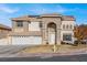 Stately two-story home featuring a grand arched entrance and three-car garage at 6192 Rocky Top Ave, Las Vegas, NV 89110