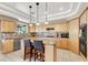 Spacious kitchen with island, pendant lighting, stainless steel appliances, and tile backsplash at 6192 Rocky Top Ave, Las Vegas, NV 89110