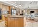 Bright kitchen featuring an island with granite countertops, pendant lights, and adjacent breakfast nook at 6192 Rocky Top Ave, Las Vegas, NV 89110