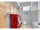 Well-organized laundry room with red washer and dryer, cabinets and drying rack at 6192 Rocky Top Ave, Las Vegas, NV 89110