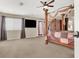 Spacious bedroom with a four-poster bed and lots of natural light at 6192 Rocky Top Ave, Las Vegas, NV 89110