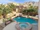 Backyard oasis featuring a pool with waterfall and spa at 6192 Rocky Top Ave, Las Vegas, NV 89110