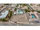 Aerial view of a property showcasing its extensive grounds, a unique rooftop pool, and surrounding neighborhood at 647 Foxhall Rd, Henderson, NV 89002