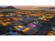 Dusk aerial shot showcases the expansive property with city views, unique lighting, and neighboring homes at 647 Foxhall Rd, Henderson, NV 89002