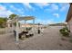 Cozy backyard patio area with modern furniture and a pergola, perfect for relaxation and outdoor gatherings at 647 Foxhall Rd, Henderson, NV 89002