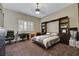 Neutral bedroom with ceiling fan, closet system, and light from a single window at 647 Foxhall Rd, Henderson, NV 89002