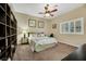 Bedroom features a ceiling fan, a large window, and neutral walls at 647 Foxhall Rd, Henderson, NV 89002