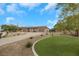 Expansive single-story home boasting a well-manicured lawn, three-car garage, and symmetrical desert landscaping at 647 Foxhall Rd, Henderson, NV 89002