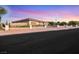 Single story home with desert landscaping and black metal fence at 647 Foxhall Rd, Henderson, NV 89002