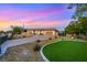 Single story home with large garage, desert landscaping, and green grass at 647 Foxhall Rd, Henderson, NV 89002