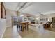 Open living room features wood floors, dining area, a ceiling fan, and sliding glass doors leading to the backyard at 647 Foxhall Rd, Henderson, NV 89002