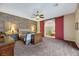 Main bedroom boasts a ceiling fan, decorative wall, and barn door access to a luxurious bathroom at 647 Foxhall Rd, Henderson, NV 89002