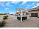 Inviting patio with modern pergola, stone flooring, and comfortable outdoor seating, perfect for entertaining at 647 Foxhall Rd, Henderson, NV 89002