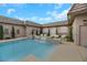 Inviting in-ground pool with elegant stone features, surrounded by lush greenery and comfortable lounge chairs at 647 Foxhall Rd, Henderson, NV 89002