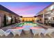 Backyard pool area with lights, landscaping, and outdoor furniture at 647 Foxhall Rd, Henderson, NV 89002