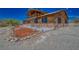 Log home exterior showcasing a side view and landscaping at 561 Miranda Rd, Pahrump, NV 89060