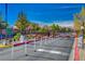 Gated community entrance to Buffalo Ranch with attractive landscaping, clear skies and visible neighborhood homes at 6724 Reggie Cir, Las Vegas, NV 89107