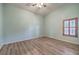 Empty bedroom with light blue walls and wood floors at 1052 Hollyhock Dr, Henderson, NV 89011