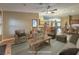 Virtually staged living room features comfortable seating and a view of the kitchen at 1052 Hollyhock Dr, Henderson, NV 89011