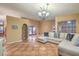 Living room with L-shaped sofa and tile flooring at 1052 Hollyhock Dr, Henderson, NV 89011