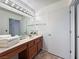 Functional bathroom featuring a vanity with sink, a large mirror, and clean lines, offering a serene and practical space at 2800 Linkview Dr, Las Vegas, NV 89134