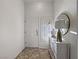 Inviting entryway with tiled floors, white wood accents, a gold mirror, and a stylish lamp, creating an elegant welcome at 2800 Linkview Dr, Las Vegas, NV 89134