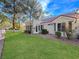 Charming exterior featuring well-kept landscaping, a red tile roof, and a lush green lawn at 2800 Linkview Dr, Las Vegas, NV 89134