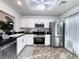 Well-lit kitchen with white cabinets, stainless steel appliances, and durable dark countertops, ready for your culinary adventures at 2800 Linkview Dr, Las Vegas, NV 89134