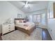 Serene main bedroom with a bay window seating area, natural light, ceiling fan, and plush bedding, perfect for relaxation at 2800 Linkview Dr, Las Vegas, NV 89134