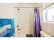 Clean bathroom featuring a shower-tub combination, a window, and a neutral color scheme at 410 Giocoso Ct, Henderson, NV 89011