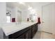 Bathroom with white quartz countertop, double sinks, black cabinetry and brushed nickel faucets at 410 Giocoso Ct, Henderson, NV 89011