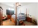 Bedroom with a four-poster bed, ceiling fan, and warm, inviting decor at 410 Giocoso Ct, Henderson, NV 89011