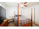 Well-lit bedroom featuring a four-poster bed, a ceiling fan, and neutral walls at 410 Giocoso Ct, Henderson, NV 89011