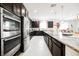 Elegant kitchen with stainless steel appliances, granite countertops, and dark wood cabinetry at 410 Giocoso Ct, Henderson, NV 89011