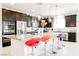 Modern kitchen with stainless steel appliances, granite countertops and colorful bar stools at 410 Giocoso Ct, Henderson, NV 89011