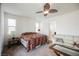 Spacious main bedroom with a ceiling fan, large windows, and comfortable seating area at 410 Giocoso Ct, Henderson, NV 89011