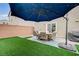 Landscaped backyard with patio set and a large shade umbrella at 5266 Sherwood Forest Ln, Las Vegas, NV 89122